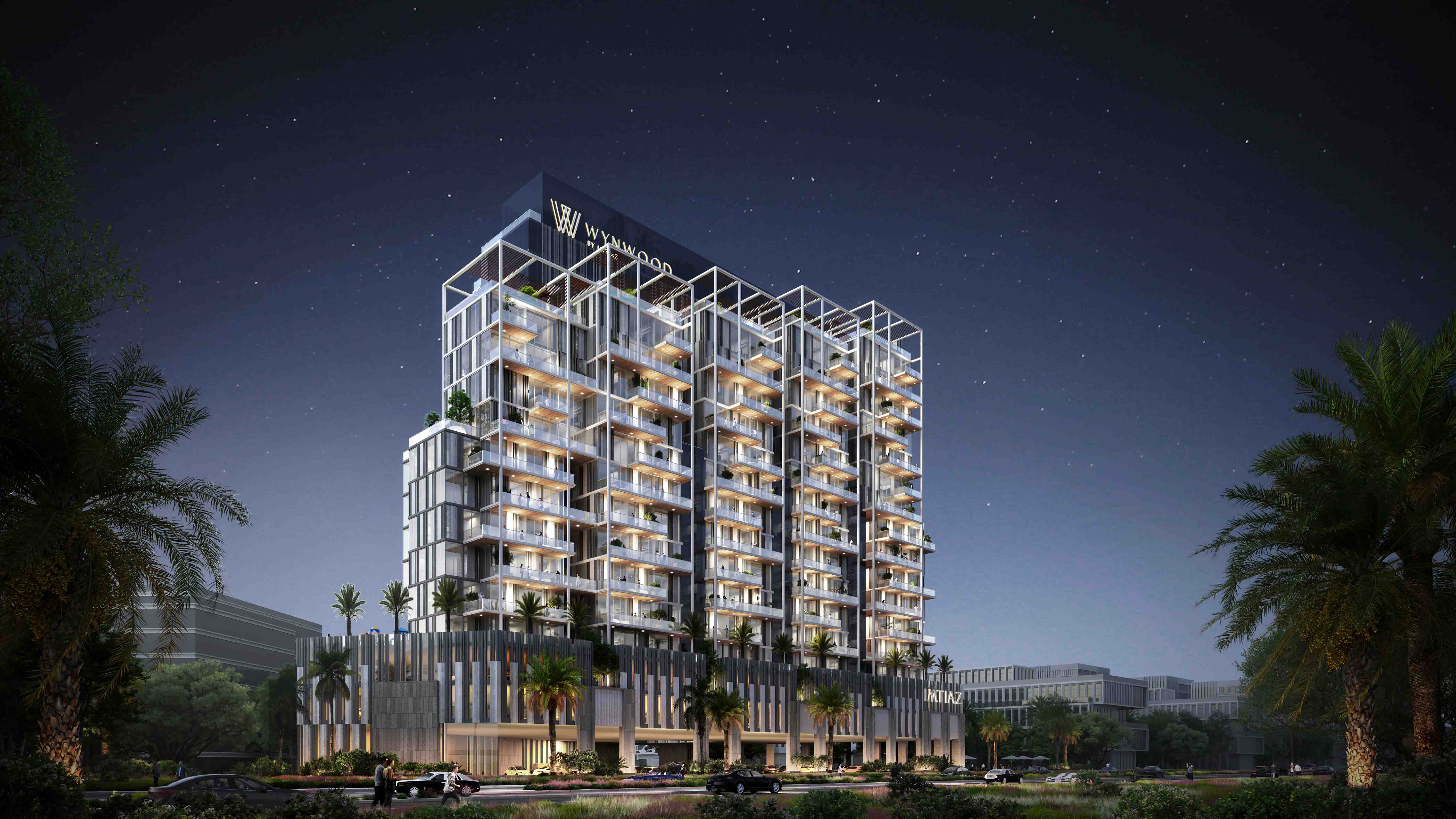 Wynwood By Imtiaz A modern multi-story building with balconies, palm trees, and a nighttime sky filled with stars.